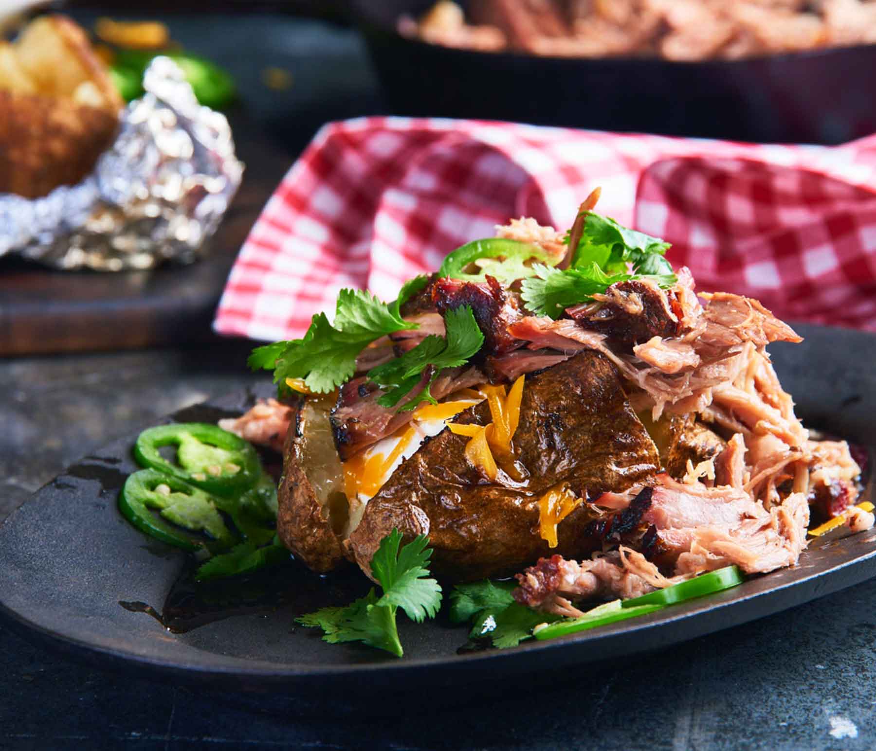 https://www.kingsford.com/wp-content/uploads/2023/05/Barbecue-Baked-Potatoes-with-Smoked-Pork-Shoulder-141_cc1_00000000_desktop2x.jpg